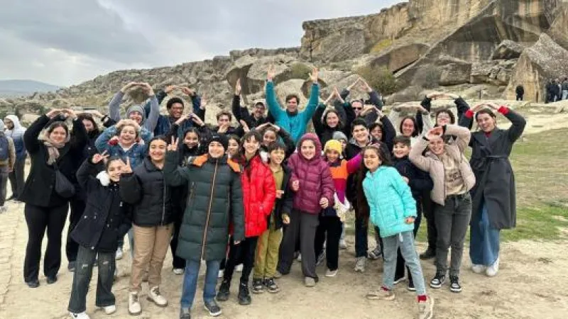 Bart Elmore, Nick Breyfogle, Ohio State students and Azerbaijani students forming O-H-I-O stance